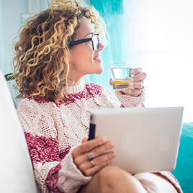 Woman holding tablet and glass of water
